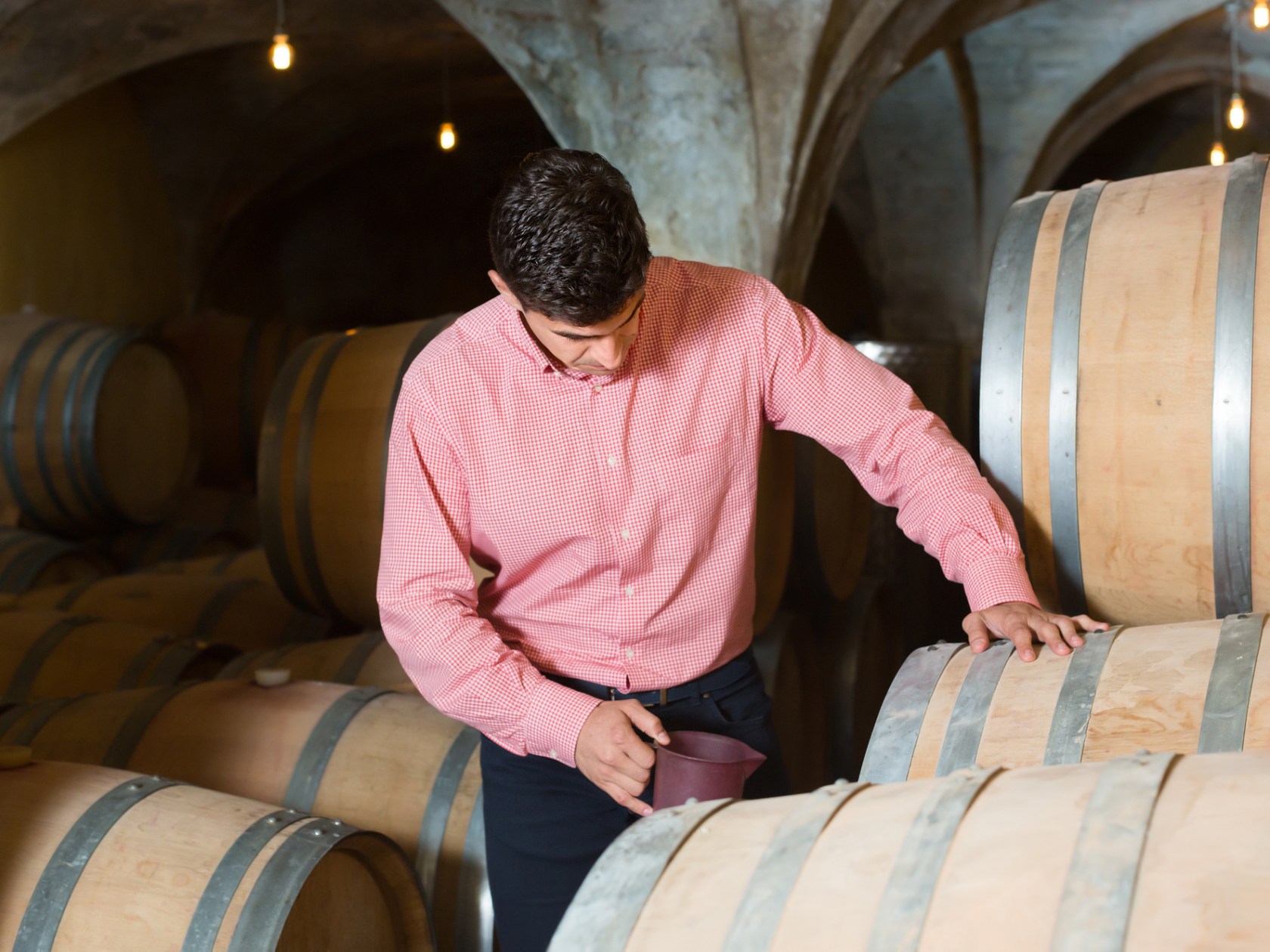 a man sitting in front of a barrel